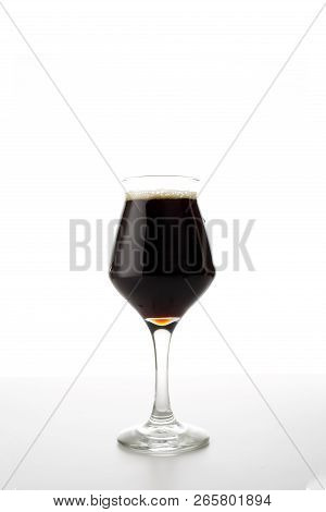 Full Beer Tulip Glass Of Stout Or Porter Isolated On White Background