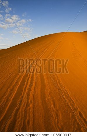 Linhas de dunas do deserto de laranja com céu azul