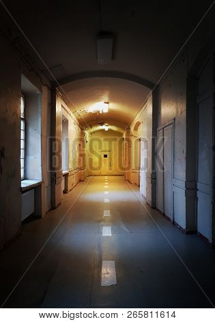Vintage Rustic Warm Lighted Tunnel With White Dotted Line Leading Forward The Door In The End