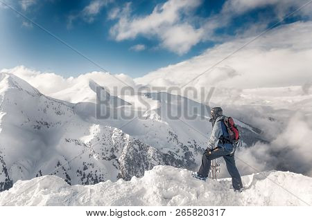 Skier Stay With Skis On Big Rock On Mountains Backdrop. Bansko, Bulgaria