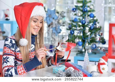 Portrait Of A Smiling Woman Preparing For Christmas