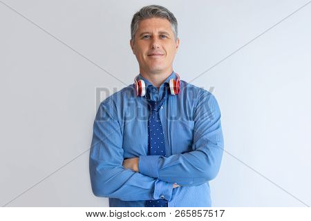 Successful Professional Enjoying Work Break. Relaxed Middle Aged Caucasian Man Posing With Loose Tie