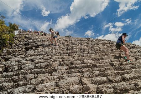 Coba, Mexico - March 1, 2016: Tourist Climb The Pyramid Nohoch Mul At The Ruins Of The Mayan City Co