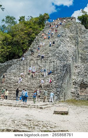 Coba, Mexico - March 1, 2016: Tourist Climb The Pyramid Nohoch Mul At The Ruins Of The Mayan City Co