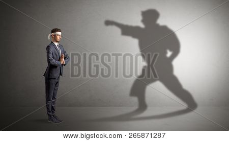 Young karate man confronting with his own shadow