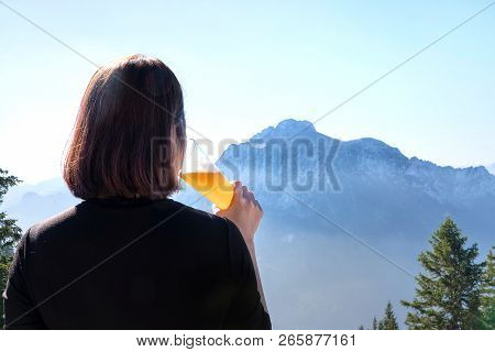Woman Lifting A Glass Of Beer And Drinking Draft Beer.happy Enjoying Harvest Time At Outdoor On Beau