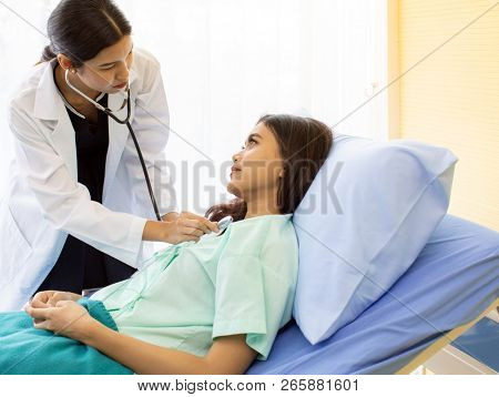 Asian Doctor make routine health check with patient in hospital ward