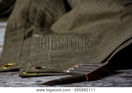 Holder With Cartridges 7, 92 X 57 - Rustic Ammos And Poncho Lies On The Wooden Background