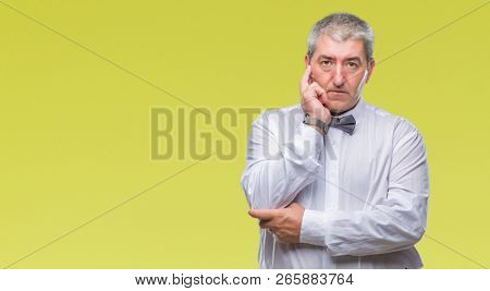 Handsome senior man wearing bow tie over isolated background thinking looking tired and bored with depression problems with crossed arms.