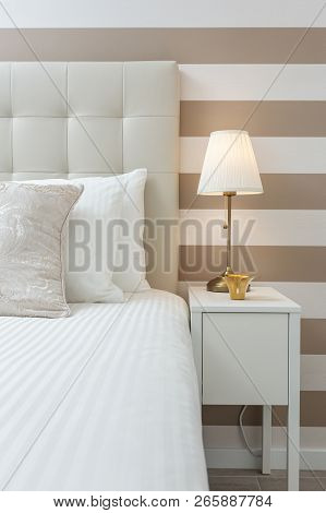 Modern Bedroom With Pillows And A Bed For Tourists. Frontally.