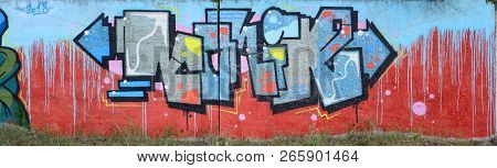 Full And Acomplished Graffiti Artwork. The Old Wall Decorated With Paint Stains In The Style Of Stre