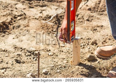 Worker Using Level At Constrcution Site