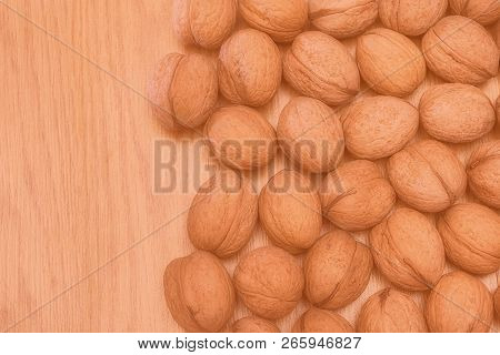 Inshell Walnuts On A Wooden Table. Healthy Food. Healthy Lifestyle. Modern Toned Photo.