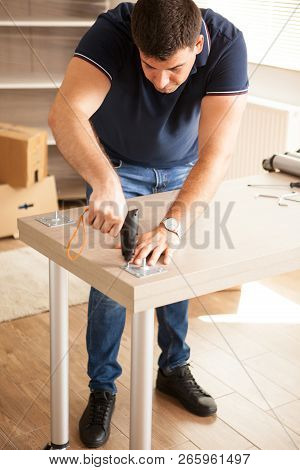 Man Assembly Furniture For New House They Purchased