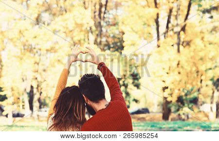 Couple In Love Shows Heart Sign With Fingers.
