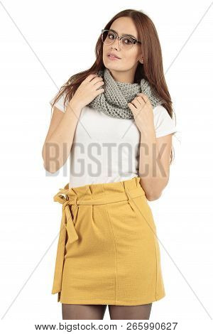 Cute Smiling Preppy, Fashion Geek Girl In A White T-shirt And Yellow Skirt