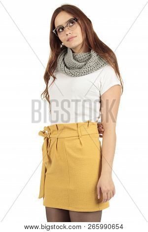 Cute Smiling Preppy, Fashion Geek Girl In A White T-shirt And Yellow Skirt
