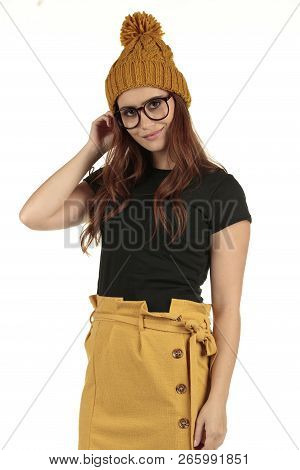 Cute Smiling Preppy, Fashion Geek Girl In A Black T-shirt And Yellow Skirt
