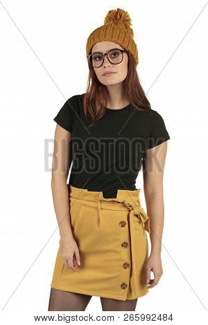 Cute Smiling Preppy, Fashion Geek Girl In A Black T-shirt And Yellow Skirt