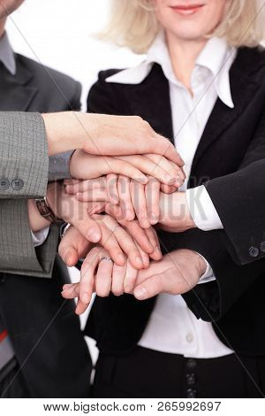 Group Of Business People With Hands Clasped Together.