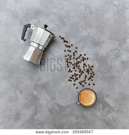 The cup of morning coffee and coffee maker with beverage from coffee beans in the form of a drink stream, place for text. Morning coffee concept. Top view.