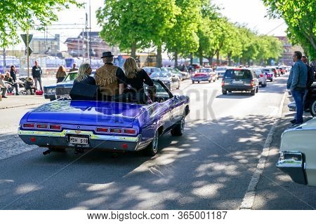 Ystad, Sweden - May 14 2019: Classic Cars Cruising In The City At Summer Meet . Lots Of People Stand