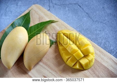 Tropical Fruits. Fresh And Beautiful Mango Fruit Set In A Wooden With Sliced Diced Mango Chunks On A