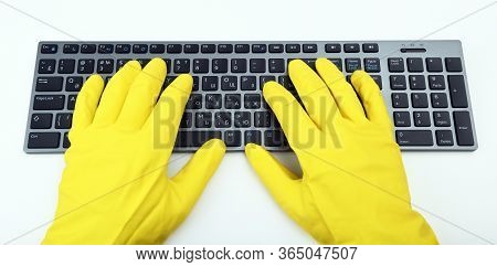 A Man In Bright Yellow Rubber Gloves Is Typing On The Keyboard. Disinfection In Public Places, The F