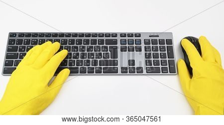 A Man In Bright Yellow Rubber Gloves Is Typing On The Keyboard. Disinfection In Public Places, The F