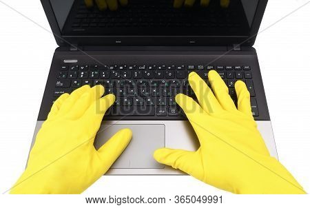 A Man In Yellow Gloves Works At A Laptop. View From Above.disinfection In Public Places, The Fight A