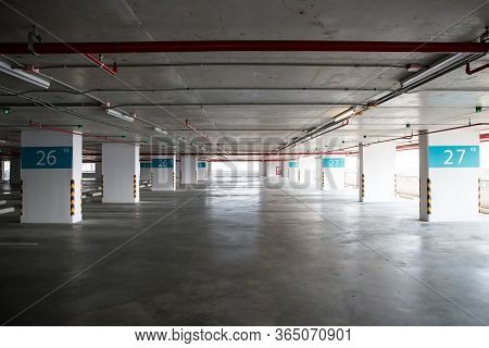 Empty Space Car Park Interior At Afternoon. Indoor Parking Lot. Interior Of Parking Garage With Car 