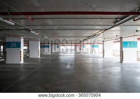 Empty Space Car Park Interior At Afternoon. Indoor Parking Lot. Interior Of Parking Garage With Car 