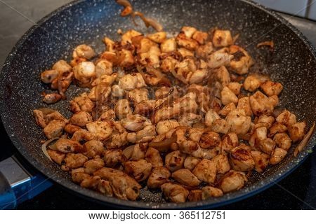 Pieces Of Chicken Fried In A Frying Pan