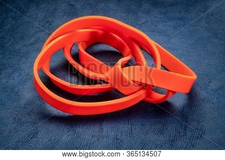 resistance exercise band for fitness and rehabilitation against blue textured background