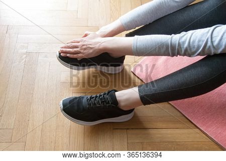 Woman Practicing Yoga, Doing Stratching Legs Pose And Back Bend On The Floor Of Light Room On Yoga M