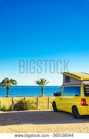 Camper Van With Tent On Roof Camping On Mediterranean Coast With Palm Trees In Spain. Percheles Beac