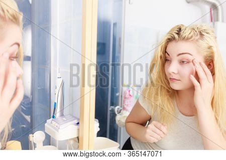 Sluggish Woman Looking At Her Skin Condition In Bathroom Mirror. Sleepy Languid Female Feeling Tired