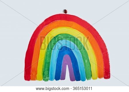 Thank To Nhs. Childrens Hand Drawing Rainbow On Paper. Greating Card For Nurses. Ladybug Sat On A Po