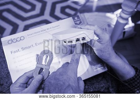 Paris, France - Circa 2020: Senior Hands Pointing To Rj45 Port Unboxing Unpacking New Parcel From Am