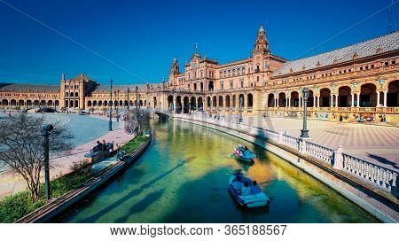 Seville, Spain - 10 February 2020 : Plaza De Espana Spain Square With Boats On The Canal In Beautifu