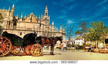 Seville, Spain - 10 February 2020 : Horses And Carriages Waiting For Tourists For A Ride In Beautifu