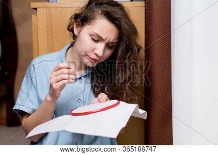 The Girl Is Unhappy, She Does Not Manage To Embroider A Cross, Something Is Going Wrong. Close-up Of