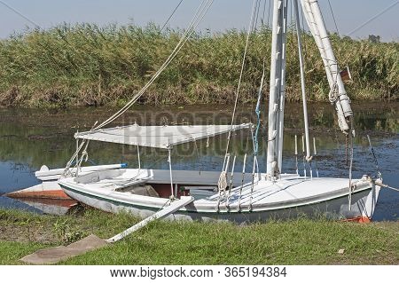 Traditional Egyptian Felluca River Sailing Boat Moored Up By The River Bank