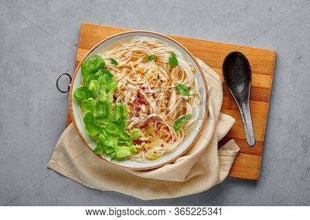 Guay Tiew Gai Cheek Or Thai Chicken Noodle Soup In White Bowl On Gray Concrete Backdrop. Guay Tiew G