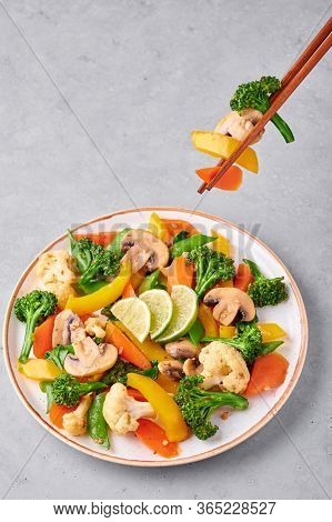 Pad Pak Ruam Or Veg Thai Stir-fried Vegetables In White Plate On Gray Concrete Backdrop. Pad Pak Is
