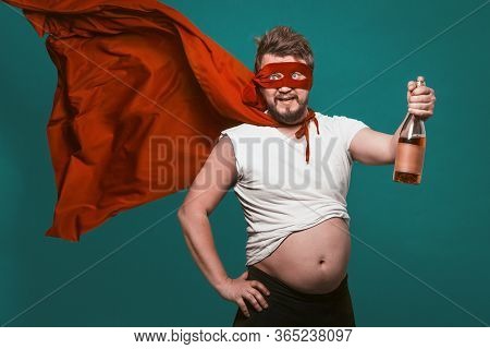 Drunk Superhero Or Antihero Man With Bottle Of Alcohol, Man In Superhero Red Mask And Fluttering Clo