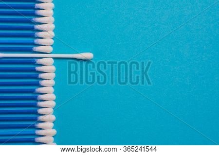 Ear Sticks On A Blue Background. Medical Sticks For Smear. Sticks For Cleaning Ears Lie In A Row, On