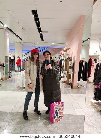Kiev, Ukraine-march 8, 2020. A Beautiful Smiling Girl With Long Hair In A Red Cap And A Woman With A