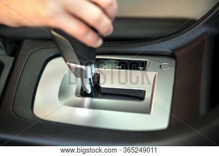 Close Up Of Woman Driver Holding Her Hand On Automatic Gear Shift Stick Driving As Car.