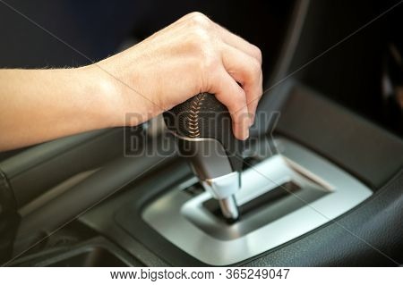 Close Up Of Woman Driver Holding Her Hand On Automatic Gear Shift Stick Driving As Car.